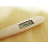 微熱を示す体温計の写真素材